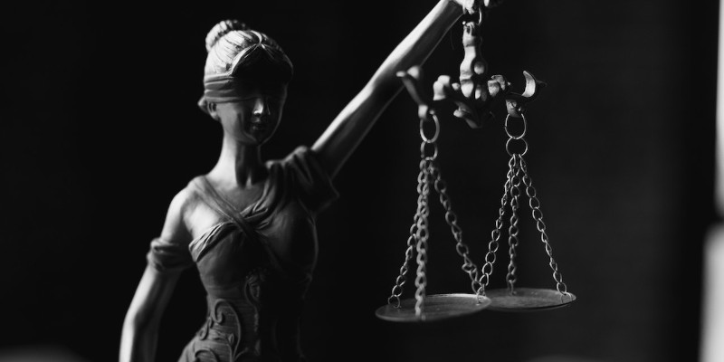 A Grayscale of a Lady Justice Figurine